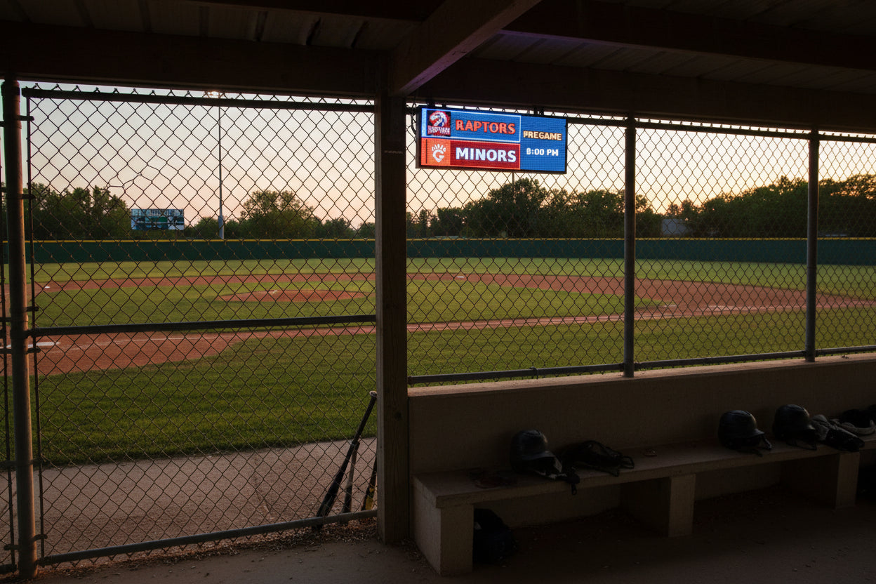 Wide real FieldFire Standard three-panel scoreboard glowing on a tabletop.