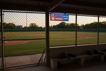 Wide real FieldFire Standard three-panel scoreboard glowing on a tabletop.